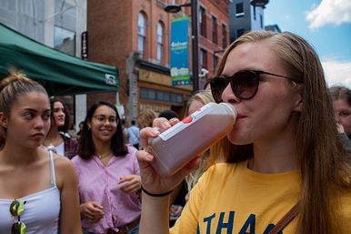 Image of Student Drinking Juice in Downtown Ithaca