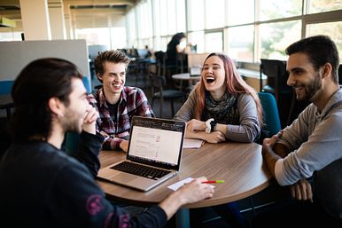 Image of Students Laughing Around a Table